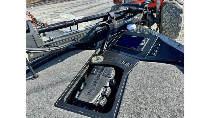 Slide: The Image of 2024 Ranger Z518 Cup-Equipped boat dashboard with Lowrance electronics and storage compartment. - 6