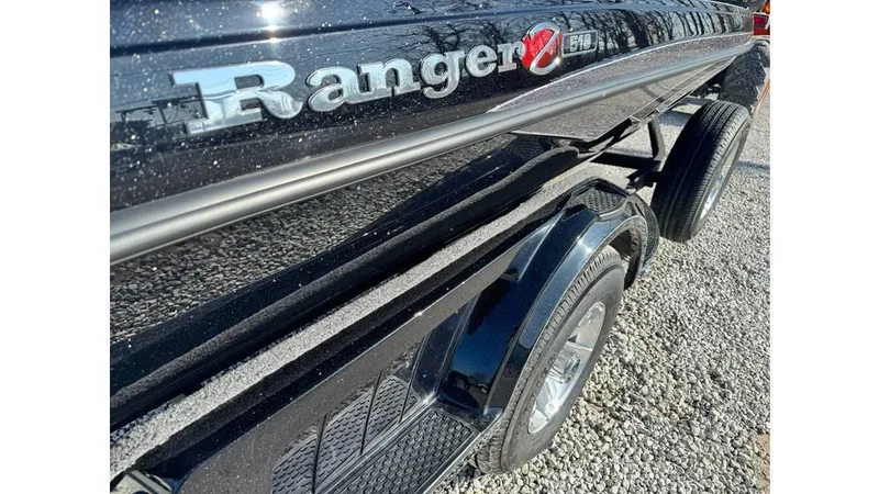 Slide: The Image of 2024 Ranger Z518 Cup-Equipped boat, black exterior, side view on gravel. - 8