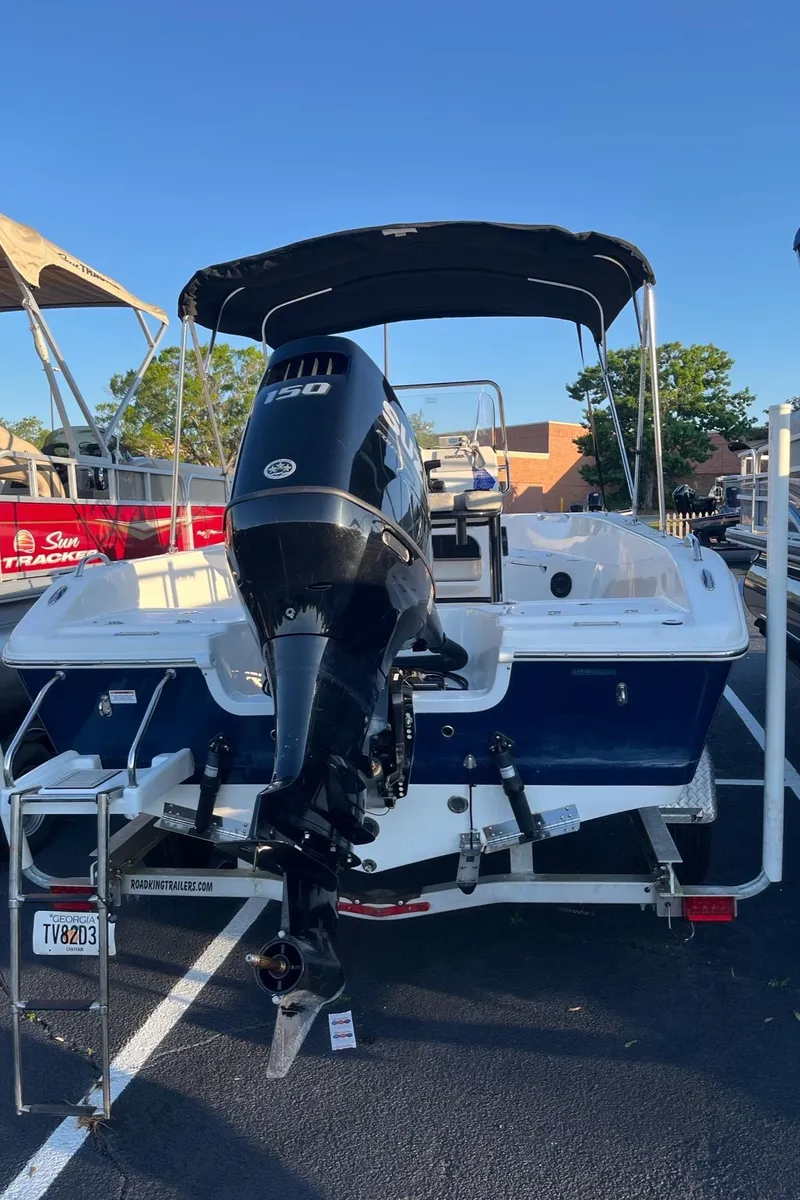Slide: The Image of 2022 Sea Pro 199 Center Console boat with outboard motor, parked on a trailer. - 3