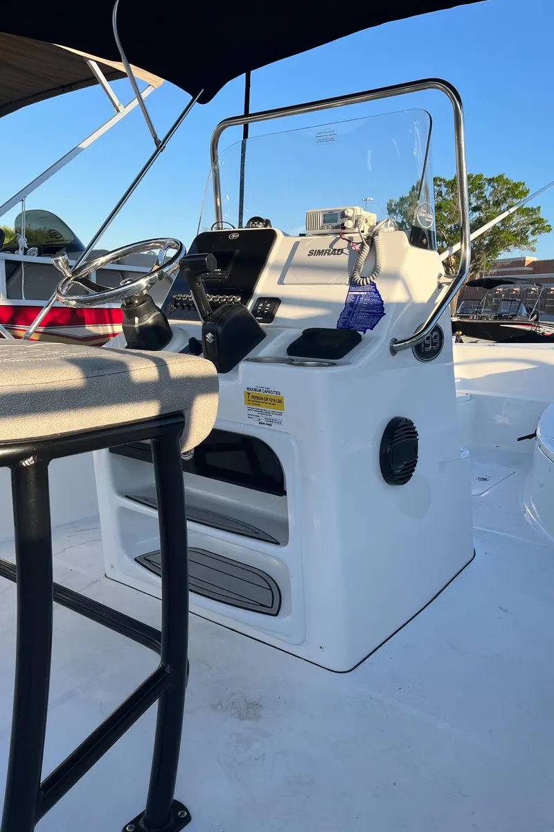 Slide: The Image of 2022 Sea Pro 199 Center Console boat with steering wheel and control panel. - 4