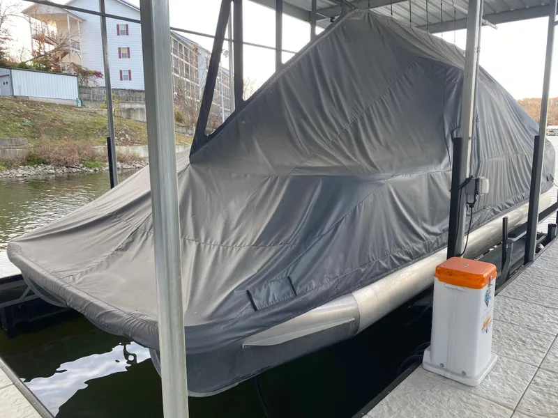 Slide: The Image of 2020 Bennington 30 QSBAX2 pontoon boat covered and docked in a marina. - 10