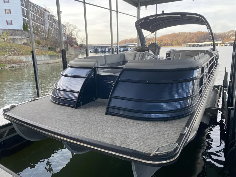 Slide: The Image of 2020 Bennington 30 QSBAX2 pontoon boat docked on a calm lake. - 11