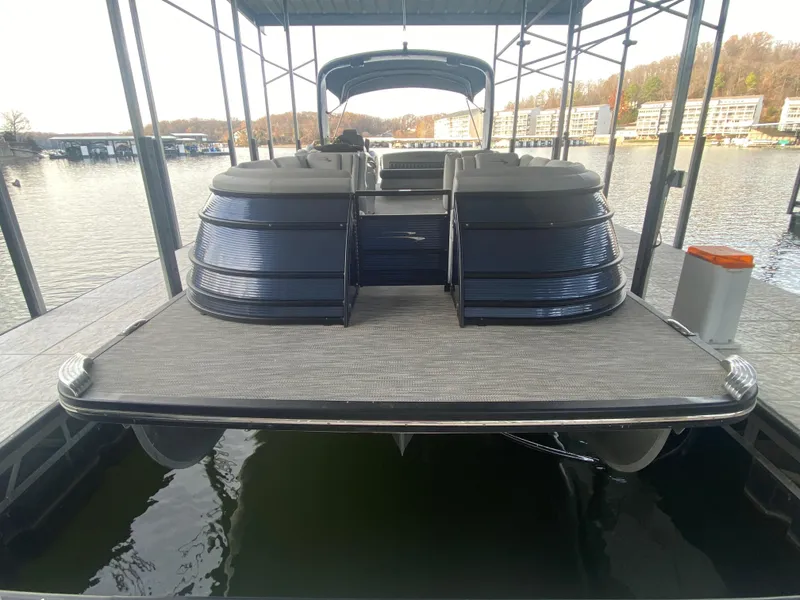 Slide: The Image of 2020 Bennington 30 QSBAX2 pontoon boat docked on a calm lake. - 12