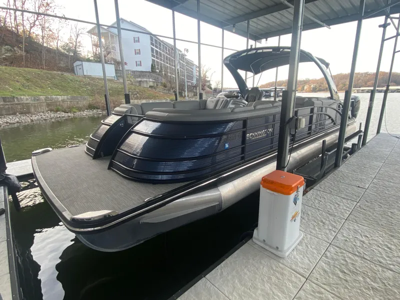 Slide: The Image of 2020 Bennington 30 QSBAX2 pontoon boat docked in a covered marina. - 13
