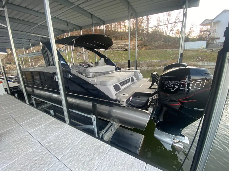 Slide: The Image of 2020 Bennington 30 QSBAX2 pontoon boat docked with Mercury 400 outboard engine. - 14