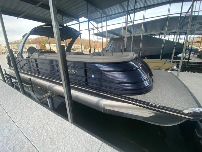 Slide: The Image of 2020 Bennington 30 QSBAX2 pontoon boat docked under a covered marina. - 16