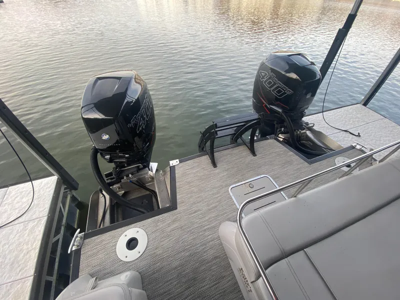 Slide: The Image of 2020 Bennington 30 QSBAX2 boat with dual outboard motors on a calm lake. - 18