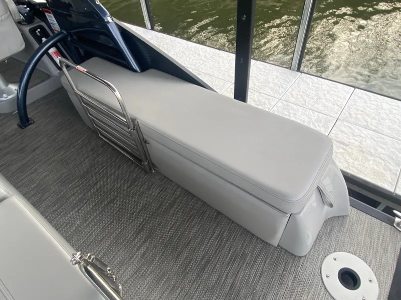 Slide: The Image of 2020 Bennington 30 QSBAX2 boat interior with gray seating and carpeted flooring. - 20