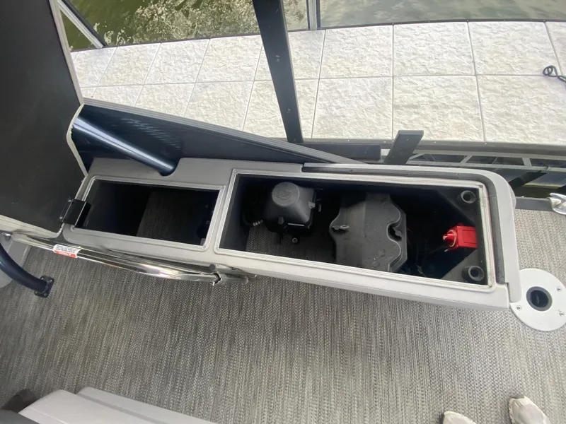 Slide: The Image of 2020 Bennington 30 QSBAX2 boat storage compartments with battery and equipment. - 21