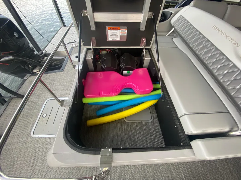 Slide: The Image of 2020 Bennington 30 QSBAX2 boat storage with colorful pool noodles and pink float. - 24