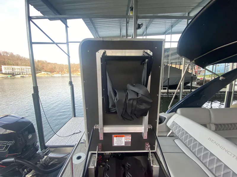 Slide: The Image of 2020 Bennington 30 QSBAX2 boat interior with storage compartment open at dock. - 25