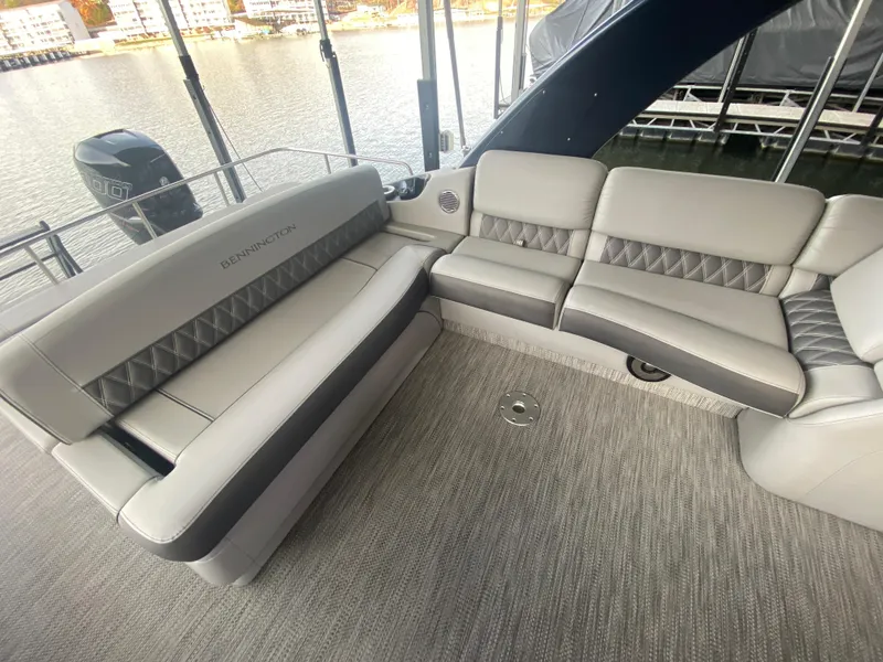 Slide: The Image of 2020 Bennington 30 QSBAX2 boat interior with luxurious gray seating and waterfront view. - 27