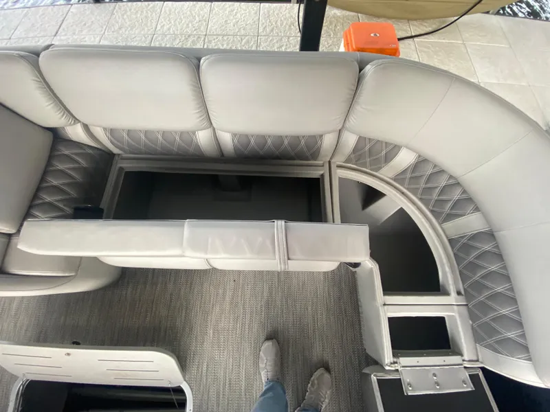 Slide: The Image of 2020 Bennington 30 QSBAX2 boat interior with gray seating and storage compartments. - 33