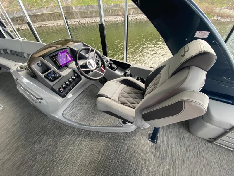 Slide: The Image of Captain's helm of 2020 Bennington 30 QSBAX2 boat with modern controls and plush seating. - 36