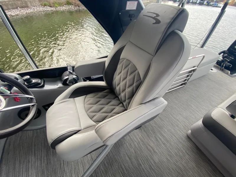 Slide: The Image of Captain's chair on 2020 Bennington 30 QSBAX2 boat, featuring quilted upholstery and sleek design. - 37
