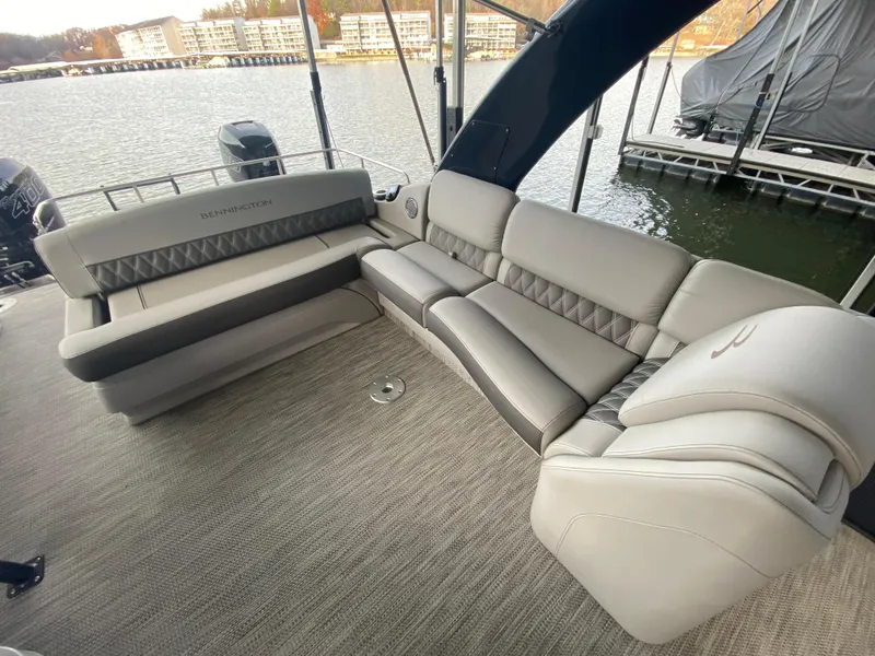 Slide: The Image of 2020 Bennington 30 QSBAX2 boat with luxurious seating on a calm waterfront. - 49