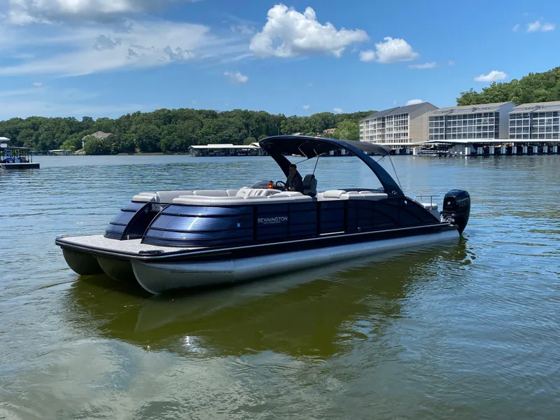 Slide: The Image of 2020 Bennington 30 QSBAX2 pontoon boat on a serene lake with blue sky. - 5