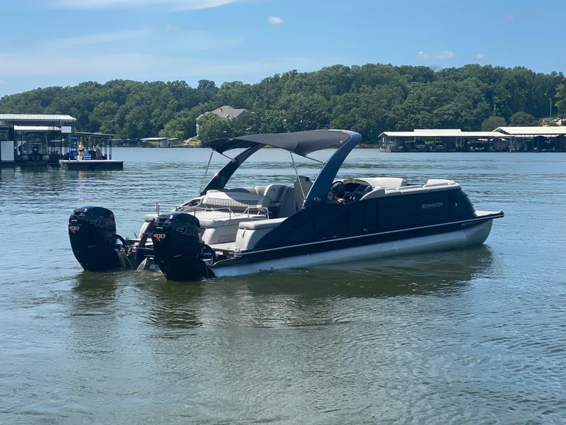 Slide: The Image of 2020 Bennington 30 QSBAX2 pontoon boat on a serene lake. - 7