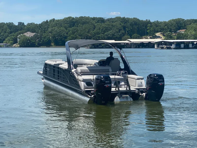 Slide: The Image of 2020 Bennington 30 QSBAX2 pontoon boat on a serene lake. - 8