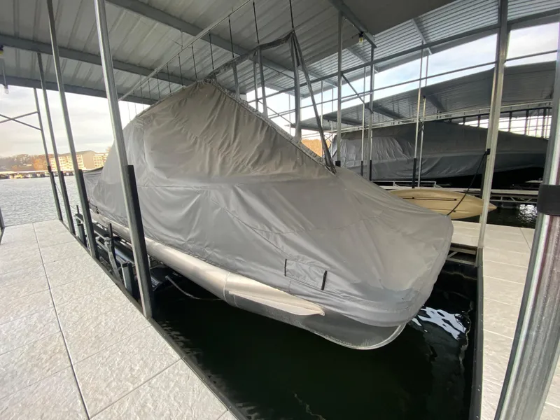 Slide: The Image of Covered 2020 Bennington 30 QSBAX2 pontoon boat docked under shelter. - 9