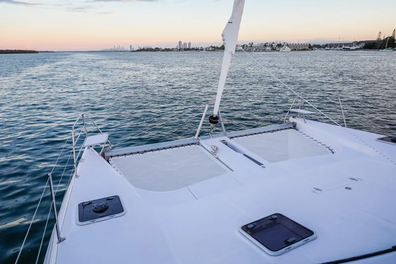 Slide: The Image of 2025 Seawind 1260 catamaran on calm waters at sunset. - 19