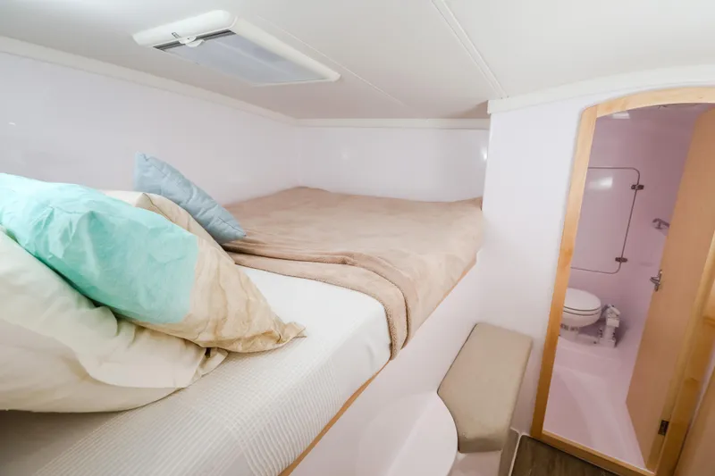 Slide: The Image of Cozy bedroom and bathroom in 2025 Seawind 1260 catamaran, featuring comfortable bedding. - 29