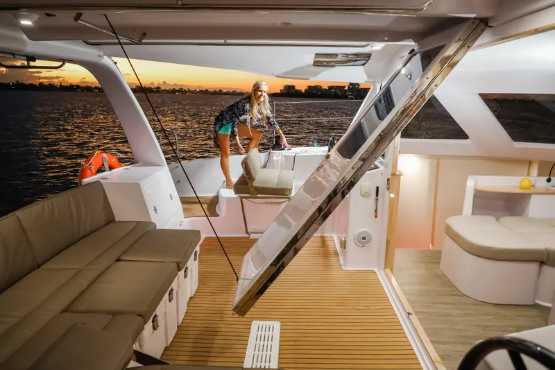 Slide: The Image of 2025 Seawind 1260 catamaran interior with sunset view, featuring spacious seating and modern design. - 32