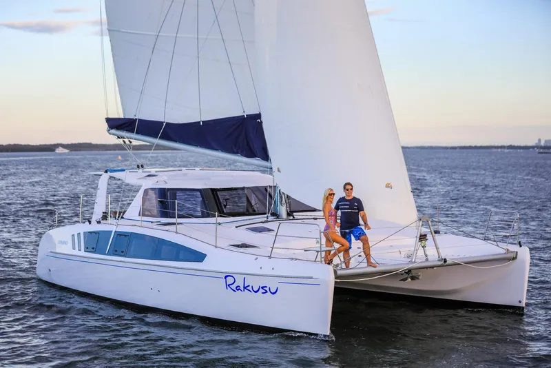 Slide: The Image of 2025 Seawind 1260 catamaran sailing with two people on deck at sunset. - 4
