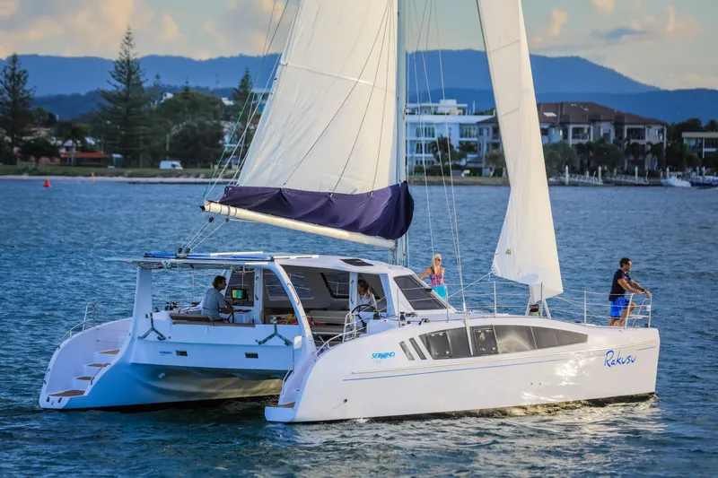Slide: The Image of 2025 Seawind 1260 catamaran sailing on a calm coastal waterway. - 6