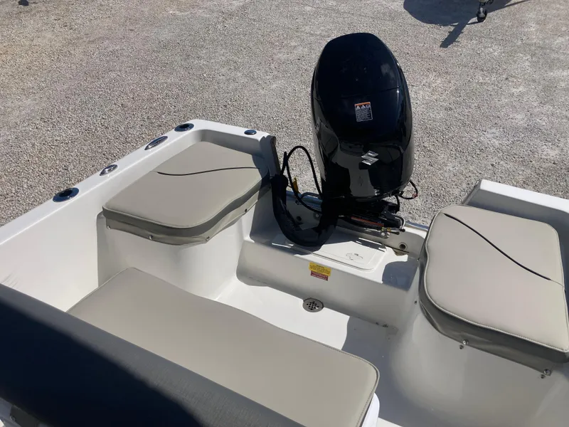 Slide: The Image of 2025 Key West 1720CC boat interior with cushioned seating and outboard motor. - 12