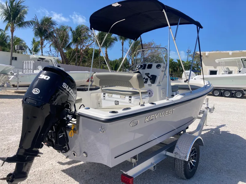 Slide: The Image of 2025 Key West 1720CC boat with Suzuki engine on trailer, parked outdoors. - 3