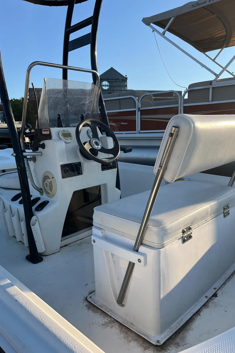 Slide: The Image of 2015 Mako Pro Skiff 17 CC boat interior with steering console and seating. - 4