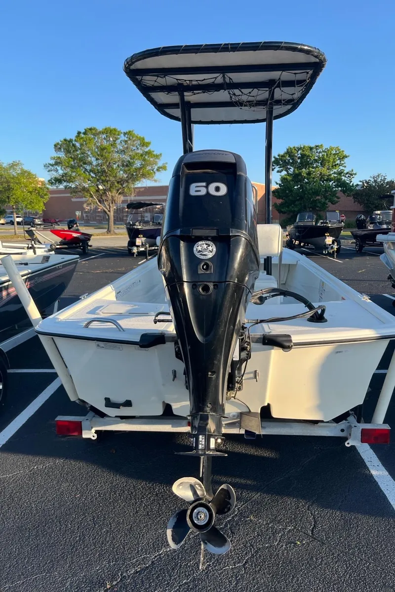 Slide: The Image of 2015 Mako Pro Skiff 17 CC with 50 HP outboard motor in parking lot. - 5
