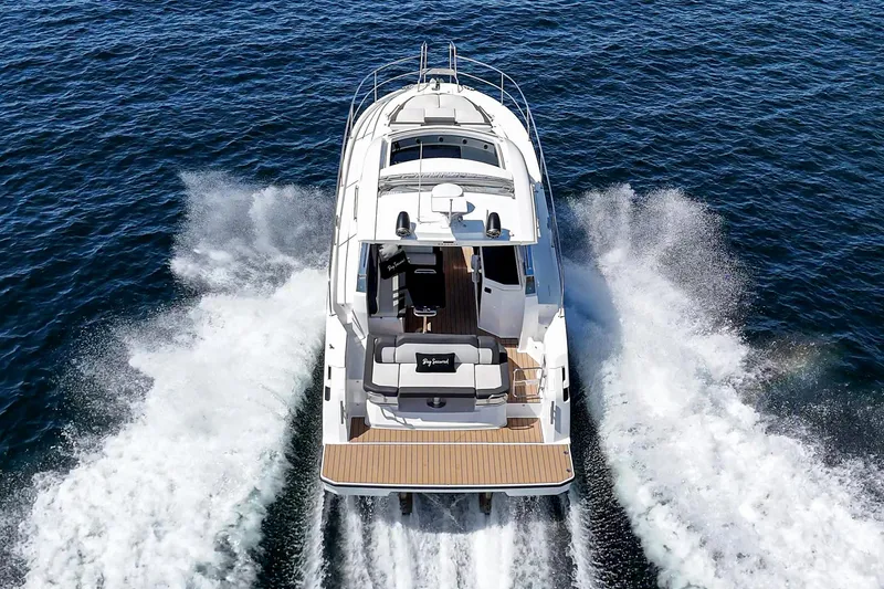 Slide: The Image of 2023 Bavaria SR36 yacht cruising on open water, rear view. - 23
