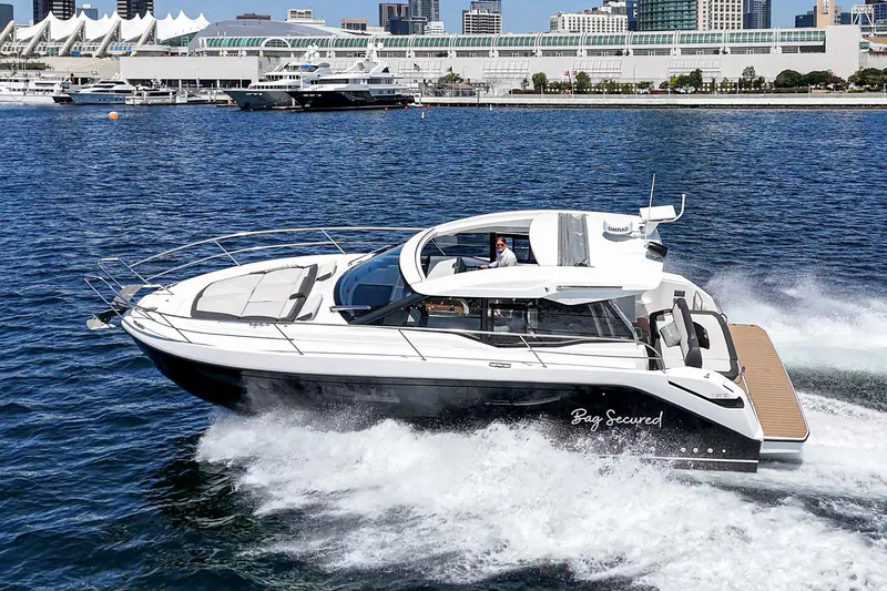 Slide: The Image of 2023 Bavaria SR36 yacht cruising in a marina with cityscape background. - 3