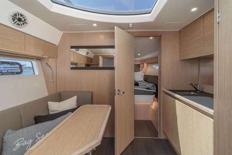 Slide: The Image of Luxurious interior of 2023 Bavaria SR36 yacht with modern wood finish and cozy seating area. - 42