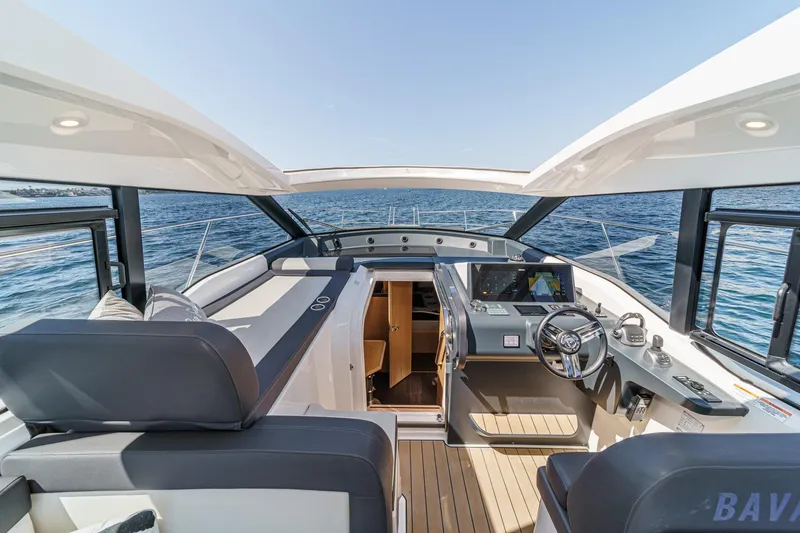 Slide: The Image of 2023 Bavaria SR36 yacht interior with modern helm, open sea view. - 31
