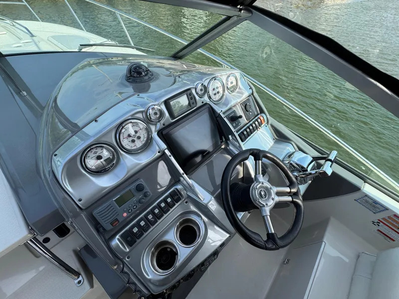 Slide: The Image of Helm of 2011 Monterey 320 Sport Yacht with modern controls and steering wheel. - 10