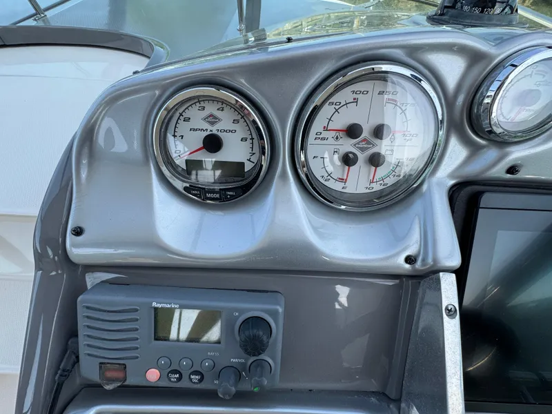 Slide: The Image of Dashboard of a 2011 Monterey 320 Sport Yacht with gauges and radio equipment. - 11