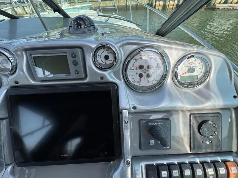 Slide: The Image of Dashboard of a 2011 Monterey 320 Sport Yacht with gauges and navigation equipment. - 12