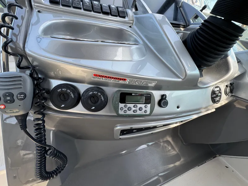 Slide: The Image of Control panel of a 2011 Monterey 320 Sport Yacht with various switches and dials. - 14