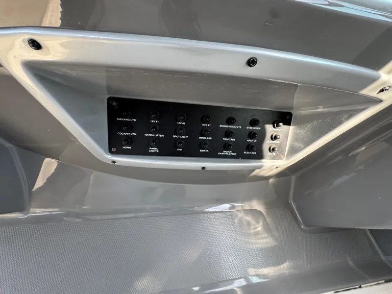 Slide: The Image of Control panel on a 2011 Monterey 320 Sport Yacht, featuring various switches and buttons. - 15