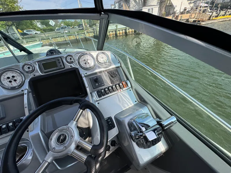 Slide: The Image of Cockpit view of 2011 Monterey 320 Sport Yacht with steering wheel and control panel. - 16