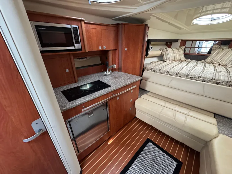 Slide: The Image of Interior of 2011 Monterey 320 Sport Yacht with kitchen and cozy sleeping area. - 19