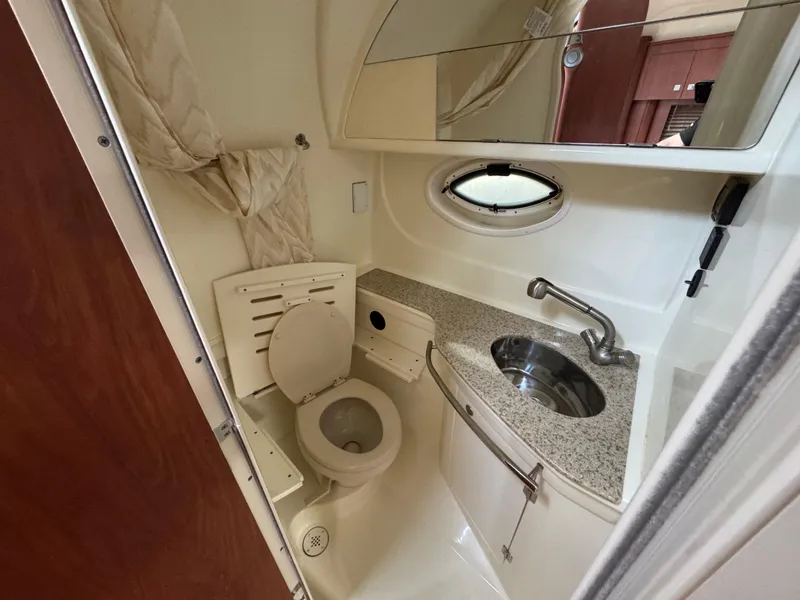 Slide: The Image of 2011 Monterey 320 Sport Yacht bathroom with toilet, sink, and mirror. - 20
