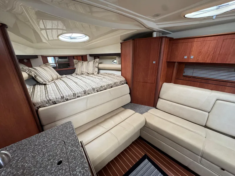 Slide: The Image of Luxurious interior of 2011 Monterey 320 Sport Yacht with cozy seating and elegant wood finishes. - 23