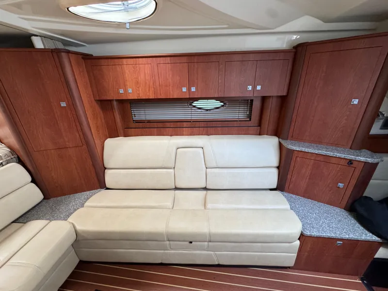 Slide: The Image of Luxurious interior of 2011 Monterey 320 Sport Yacht with beige seating and wooden cabinetry. - 24