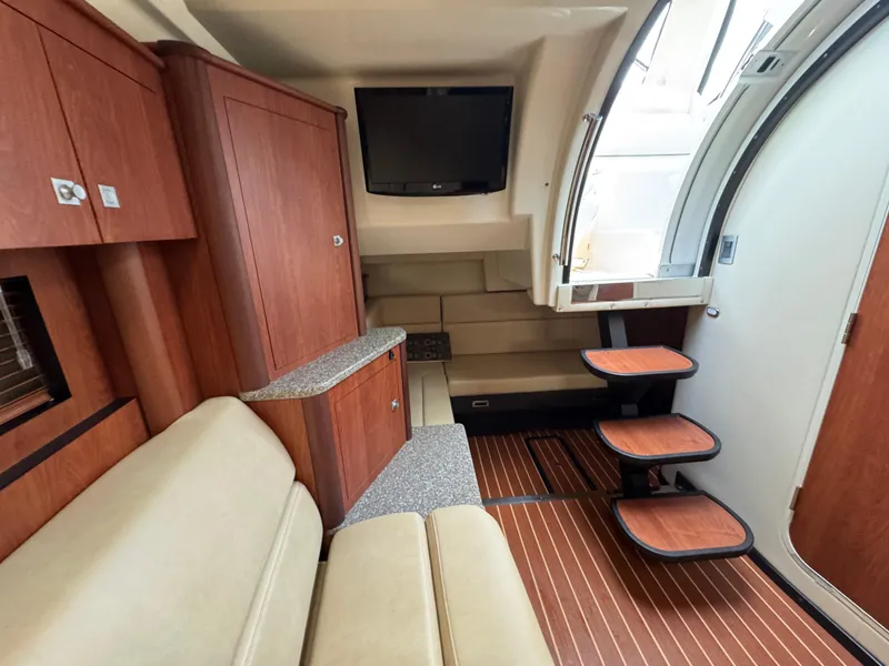 Slide: The Image of Interior of 2011 Monterey 320 Sport Yacht with wood accents and seating area. - 25