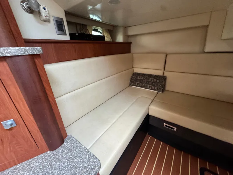 Slide: The Image of Interior of 2011 Monterey 320 Sport Yacht with beige seating and wood accents. - 27