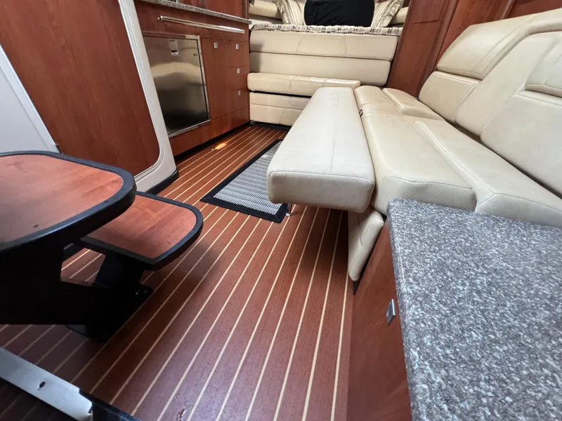 Slide: The Image of Interior of 2011 Monterey 320 Sport Yacht with leather seating and wood flooring. - 28